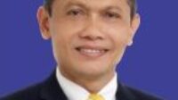 A person in a suit and tieDescription automatically generated with medium confidence